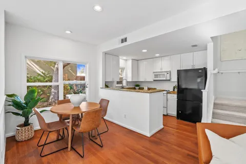 a kitchen with a table and chairs