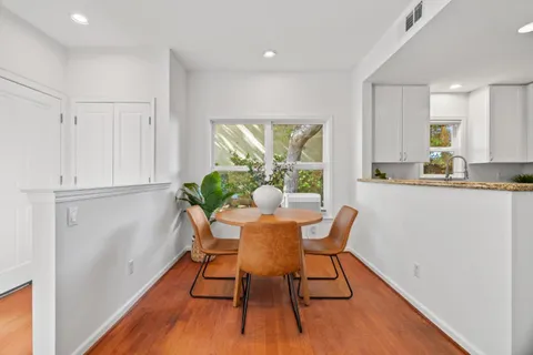 a dining room with furniture and a window
