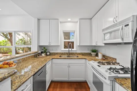 a kitchen with a stove a sink and a microwave