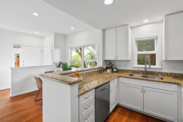 a kitchen with a sink stove and cabinets