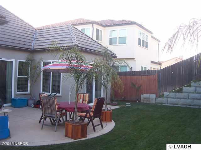 513 Andromeda Drive Lompoc, CA 93436 - Photo 5 of 15 a view of a chairs and table in backyard of the house