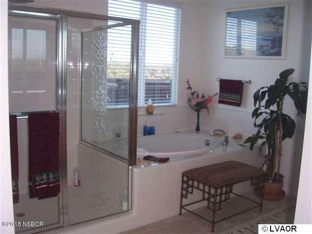 513 Andromeda Drive Lompoc, CA 93436 - Photo 10 of 15 a bathroom with a tub sink and mirror