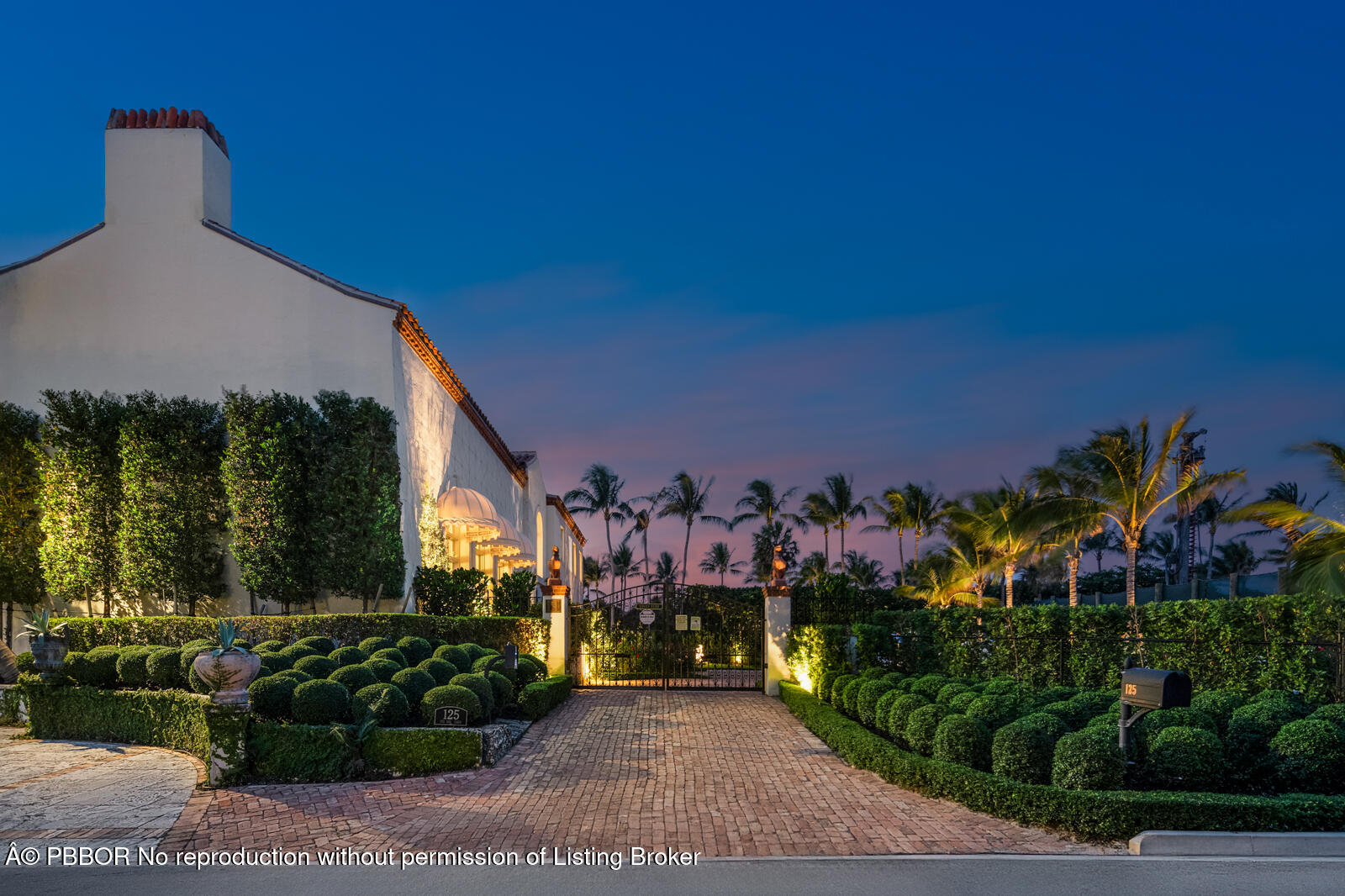 111 Via Del Lago Palm Beach, FL 33480 - Photo 12 of 72 a front view of a house with a yard and a garden
