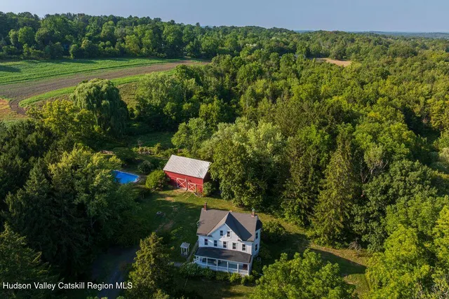 a sign that is sitting on a lush green field near a garden