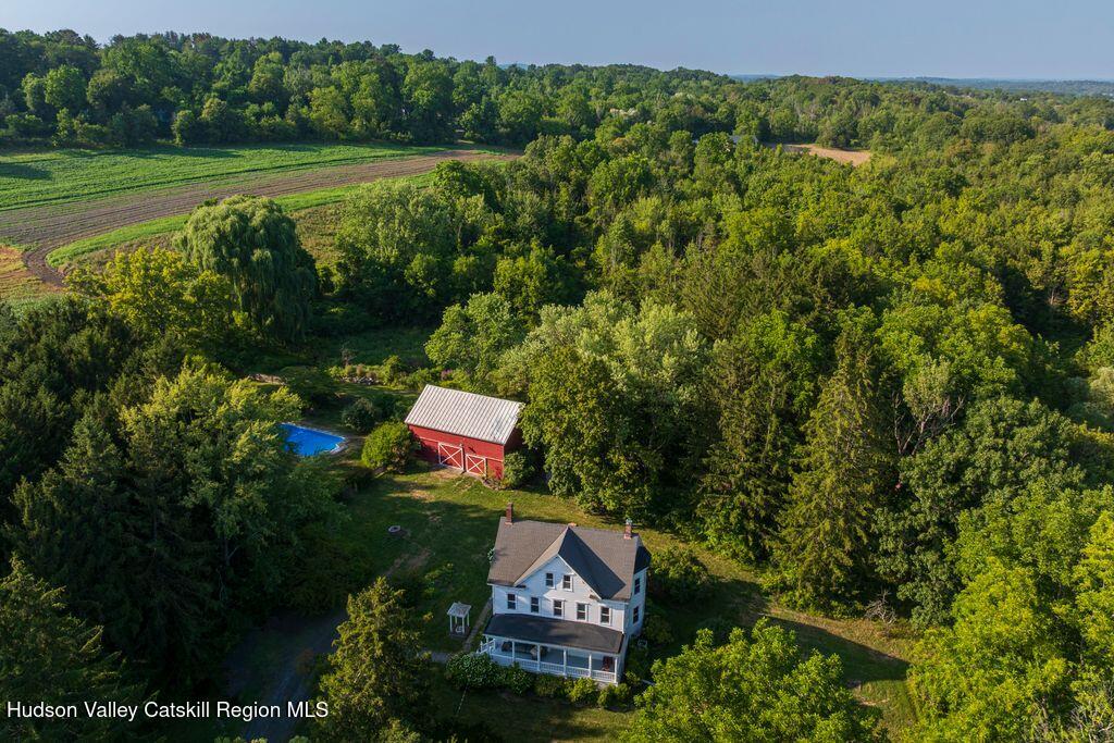 a sign that is sitting on a lush green field near a garden