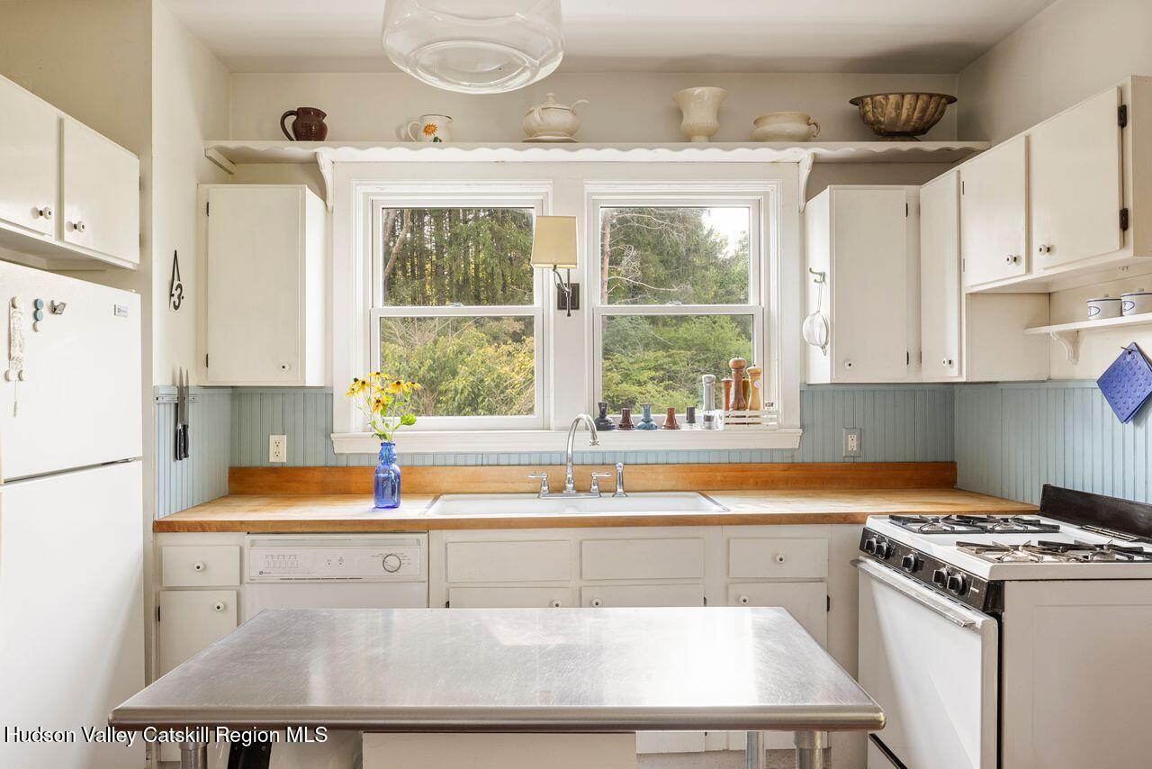 276 Leeds Athens Road Athens, NY 12015 - Photo 11 of 27 a kitchen with a sink a stove and white cabinets with wooden floors