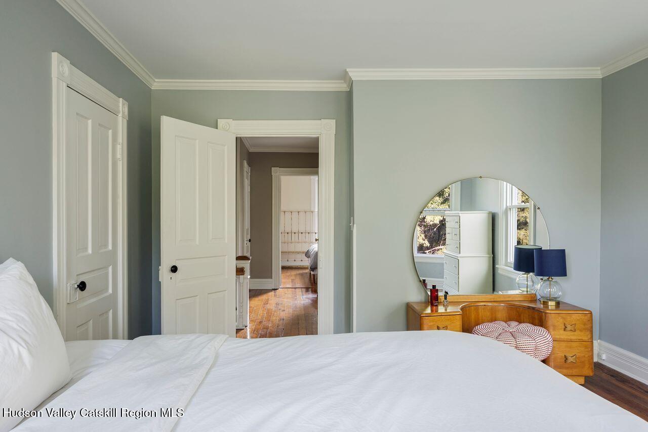276 Leeds Athens Road Athens, NY 12015 - Photo 13 of 27 a bedroom with a large bed and a mirror