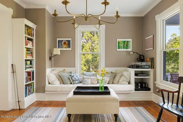 a living room with furniture and a book shelf