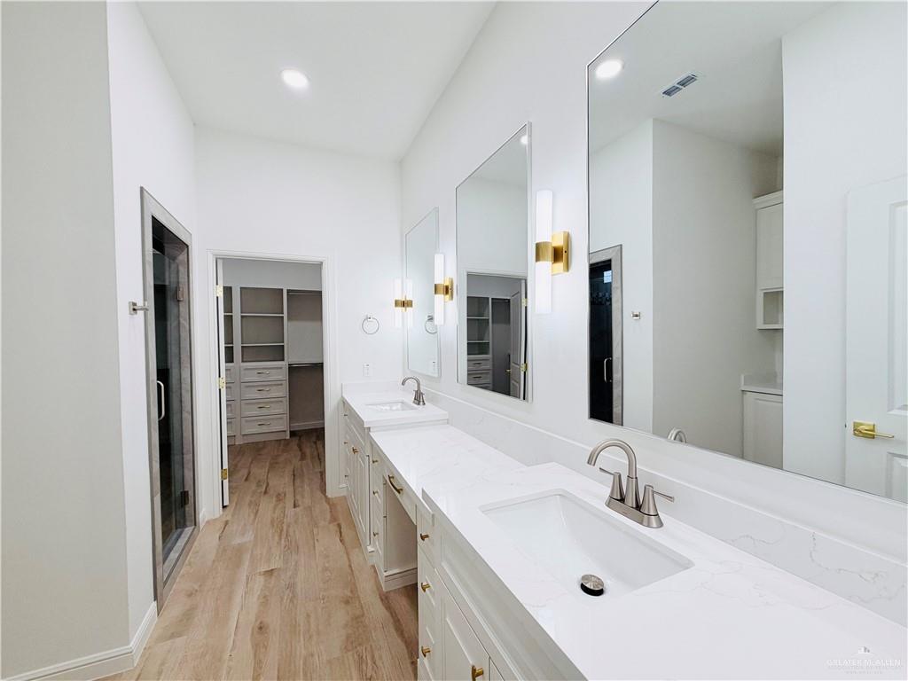 807 Ramirez Street Mission, TX 78573 - Photo 8 of 16 Dual vanity with white cabinetry, quartz countertops, and undermount sinks