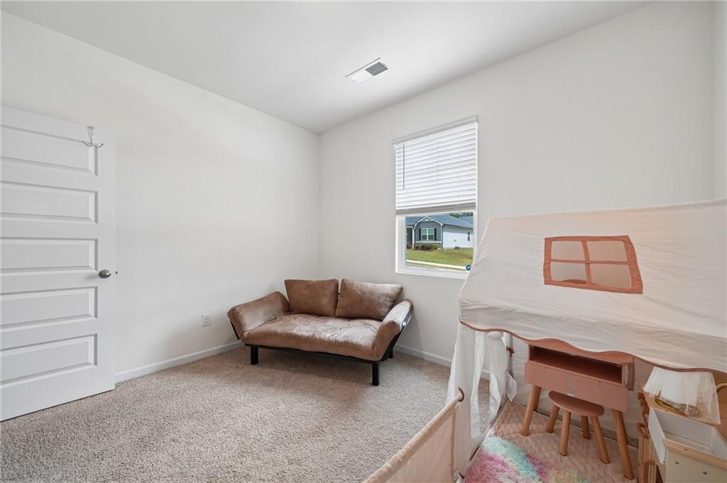 8592 Seabiscuit Road Lithonia, GA 30058 - Photo 17 of 25 a living room with furniture and a window