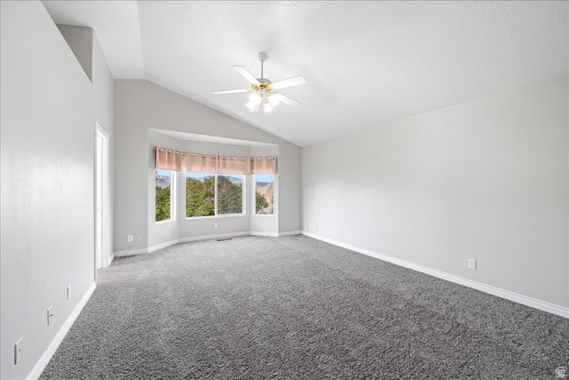 7 Reflection Way St. George, UT 84770 - Photo 40 of 54 Carpeted empty room with vaulted ceiling and ceiling fan