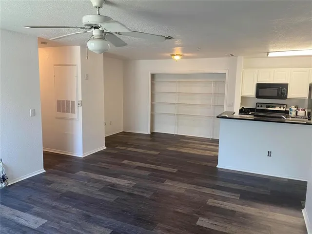 a view of kitchen and empty room