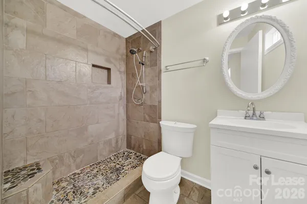 a bathroom with a sink toilet and shower