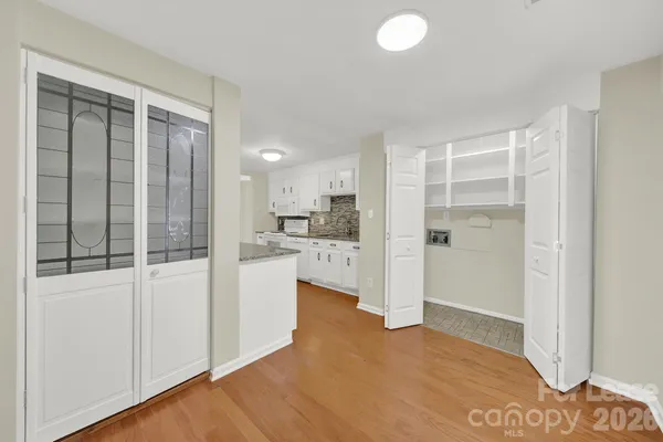 a view of a kitchen with a sink and a refrigerator