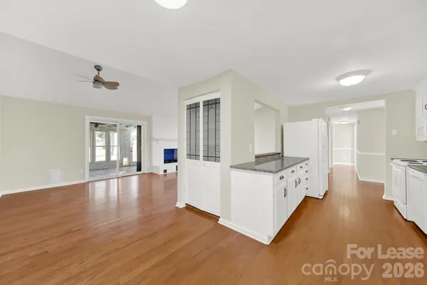 a view of kitchen with furniture and wooden floor