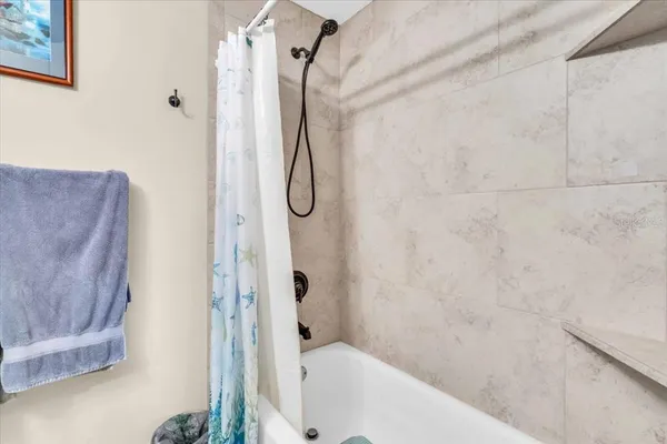 a bathroom with a bathtub and shower