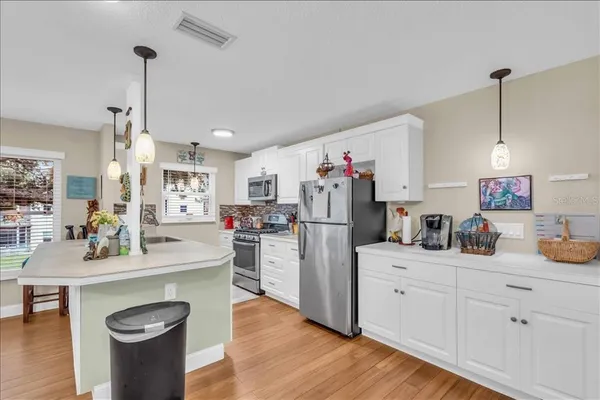 a kitchen with refrigerator and cabinets