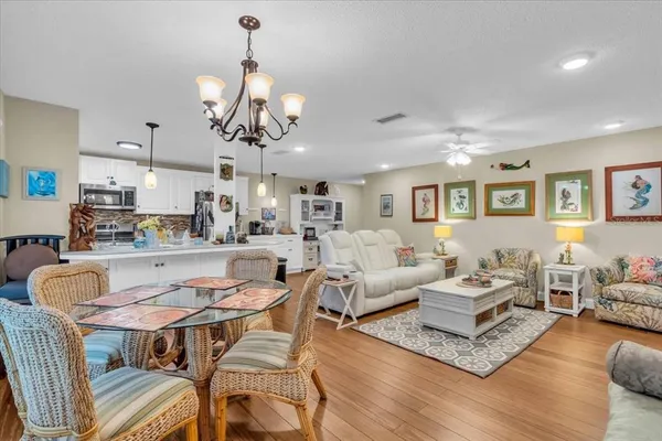 a living room with lots of furniture and view of kitchen