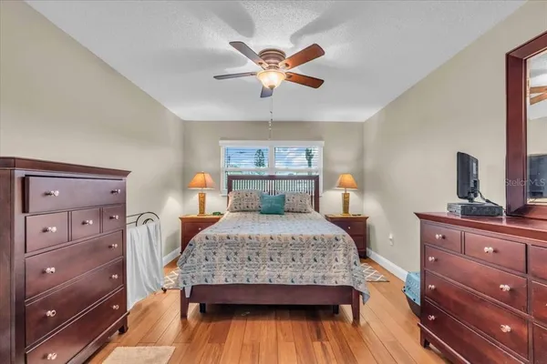 a bedroom with a bed and wooden floor