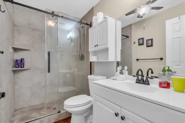 a bathroom with a sink toilet and shower