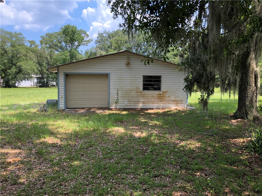 86082 Pages Dairy Road Yulee, FL 32097 - Photo 3 of 3 a backyard of a house with lots of green space