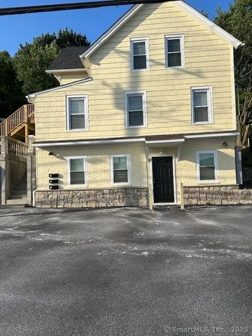 a front view of a house with a road