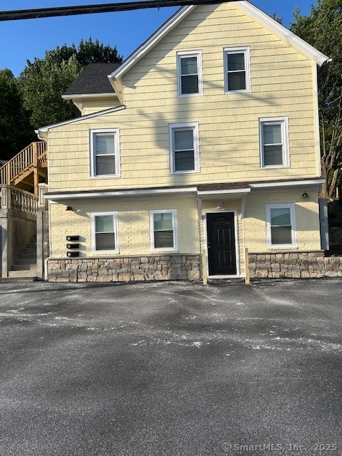 a front view of a house with a road