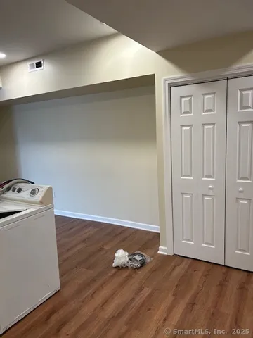 a view of room with wooden floor