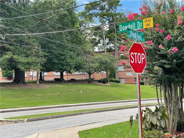 a view of a street with large trees