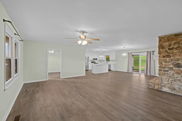 a kitchen with stainless steel appliances a refrigerator sink and wooden floor