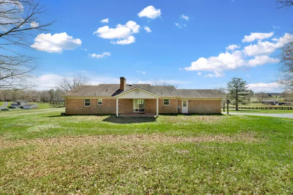 a view of a house with a backyard