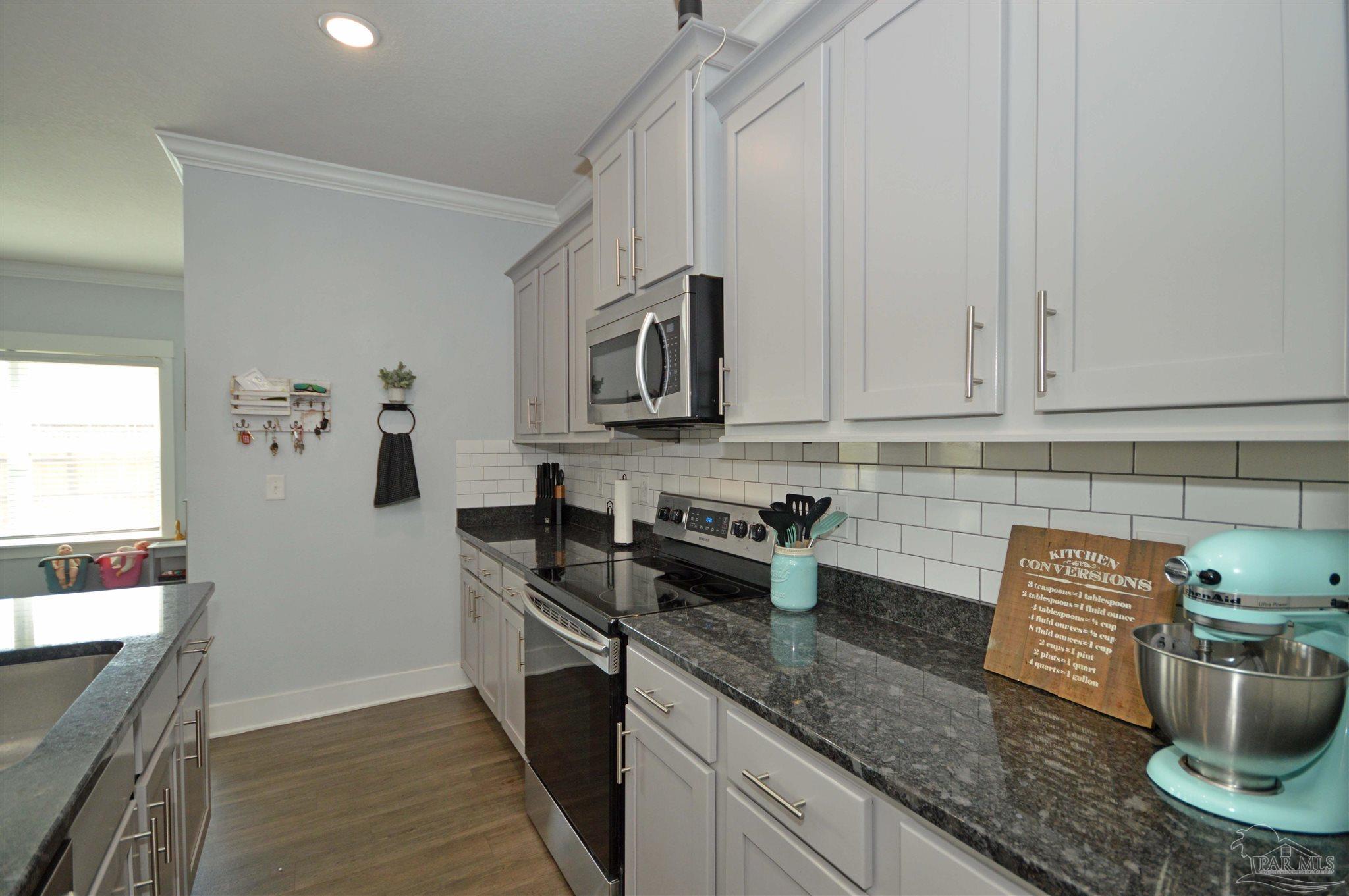 4453 Jude Way Pace, FL 32571 - Photo 14 of 41 a kitchen with a sink and cabinets