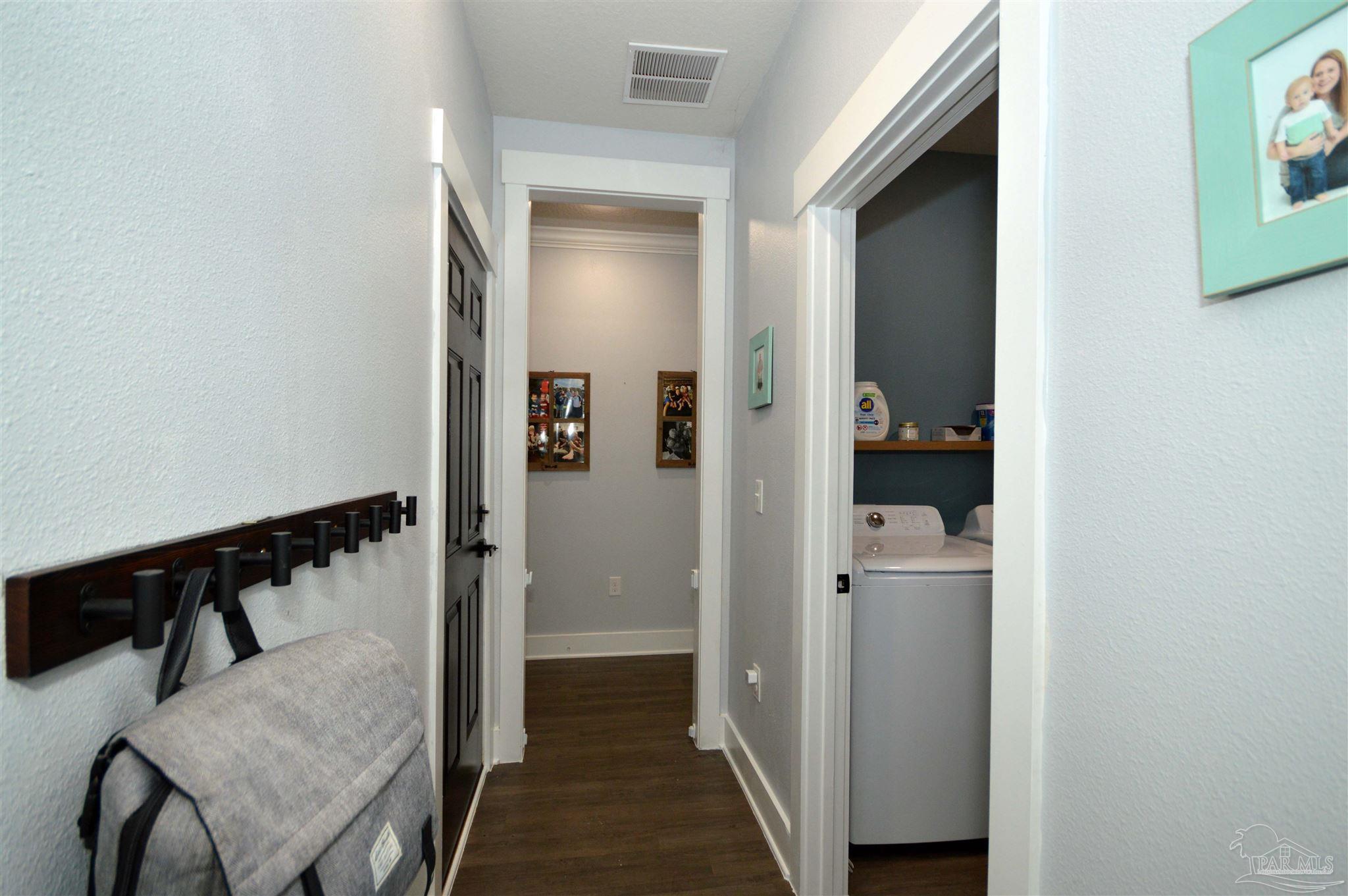 4453 Jude Way Pace, FL 32571 - Photo 21 of 41 a view of a hallway with wooden floor and entryway