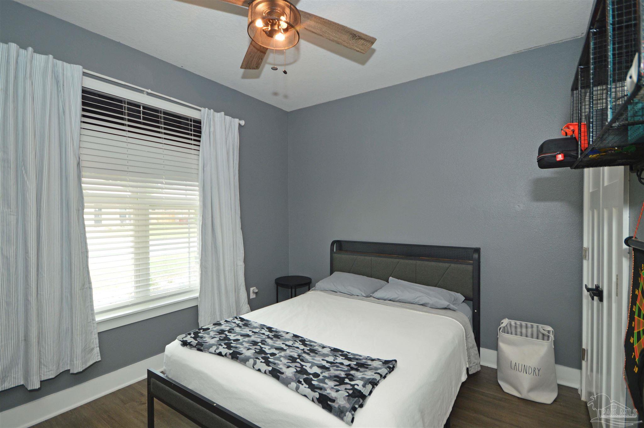 4453 Jude Way Pace, FL 32571 - Photo 26 of 41 a bedroom with a bed and a window