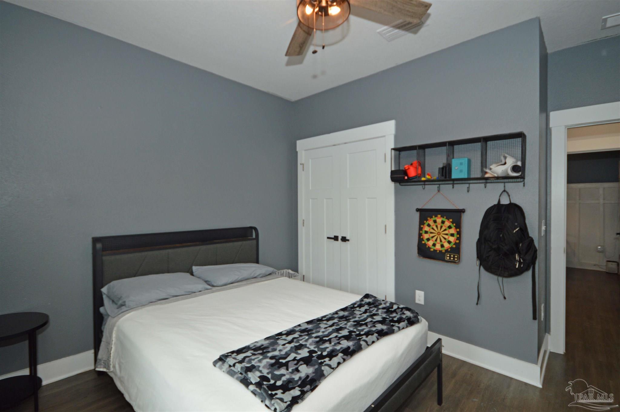 4453 Jude Way Pace, FL 32571 - Photo 27 of 41 a bedroom with a bed and cabinets