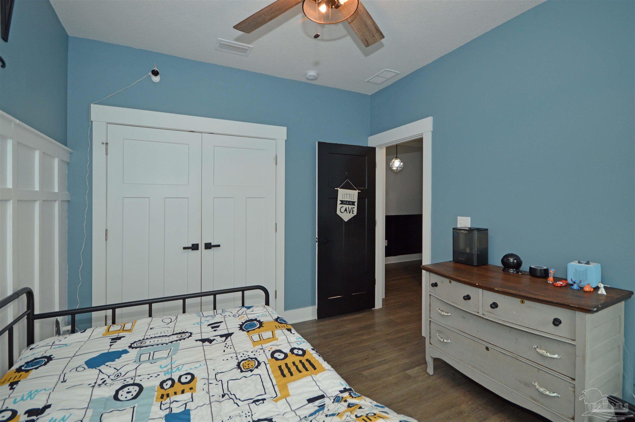 4453 Jude Way Pace, FL 32571 - Photo 28 of 41 a bed room with a bed and a dresser