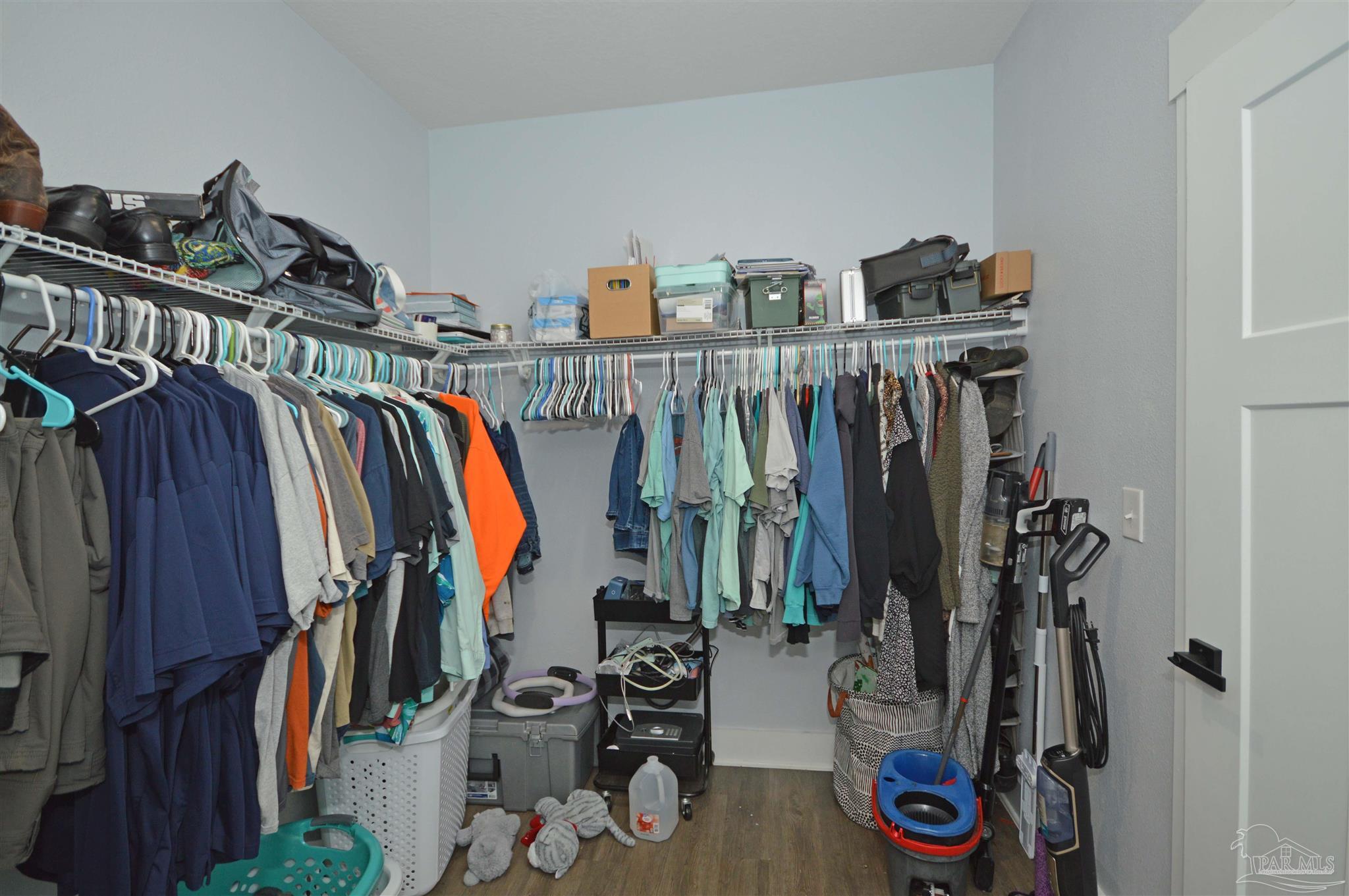 4453 Jude Way Pace, FL 32571 - Photo 35 of 41 a view of walk in closet with clothes and shoes