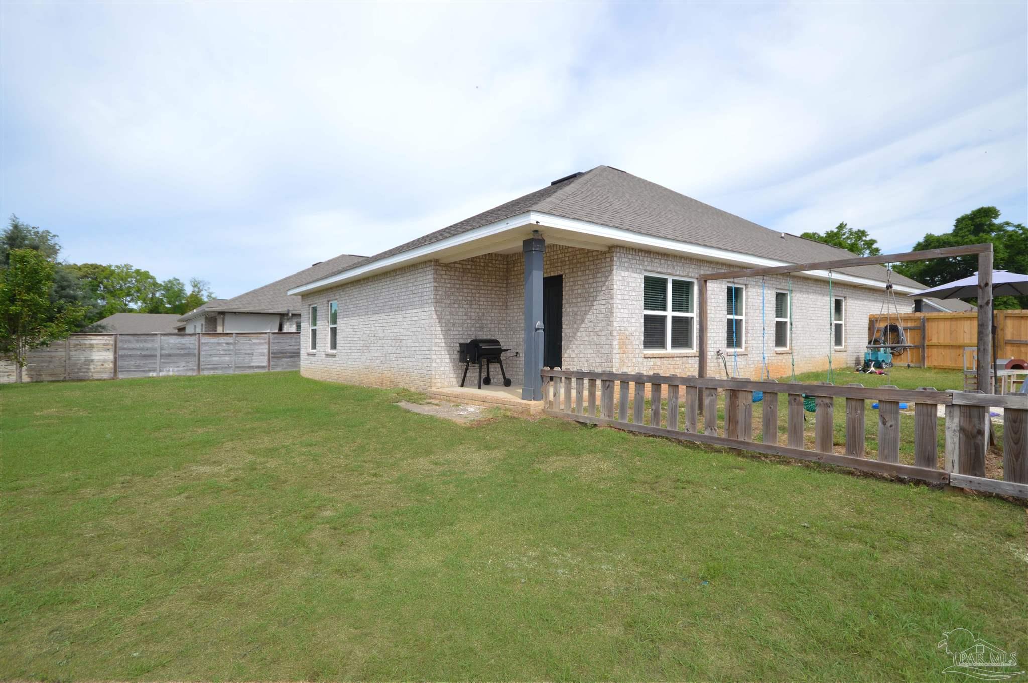 4453 Jude Way Pace, FL 32571 - Photo 40 of 41 a front view of a house with a garden