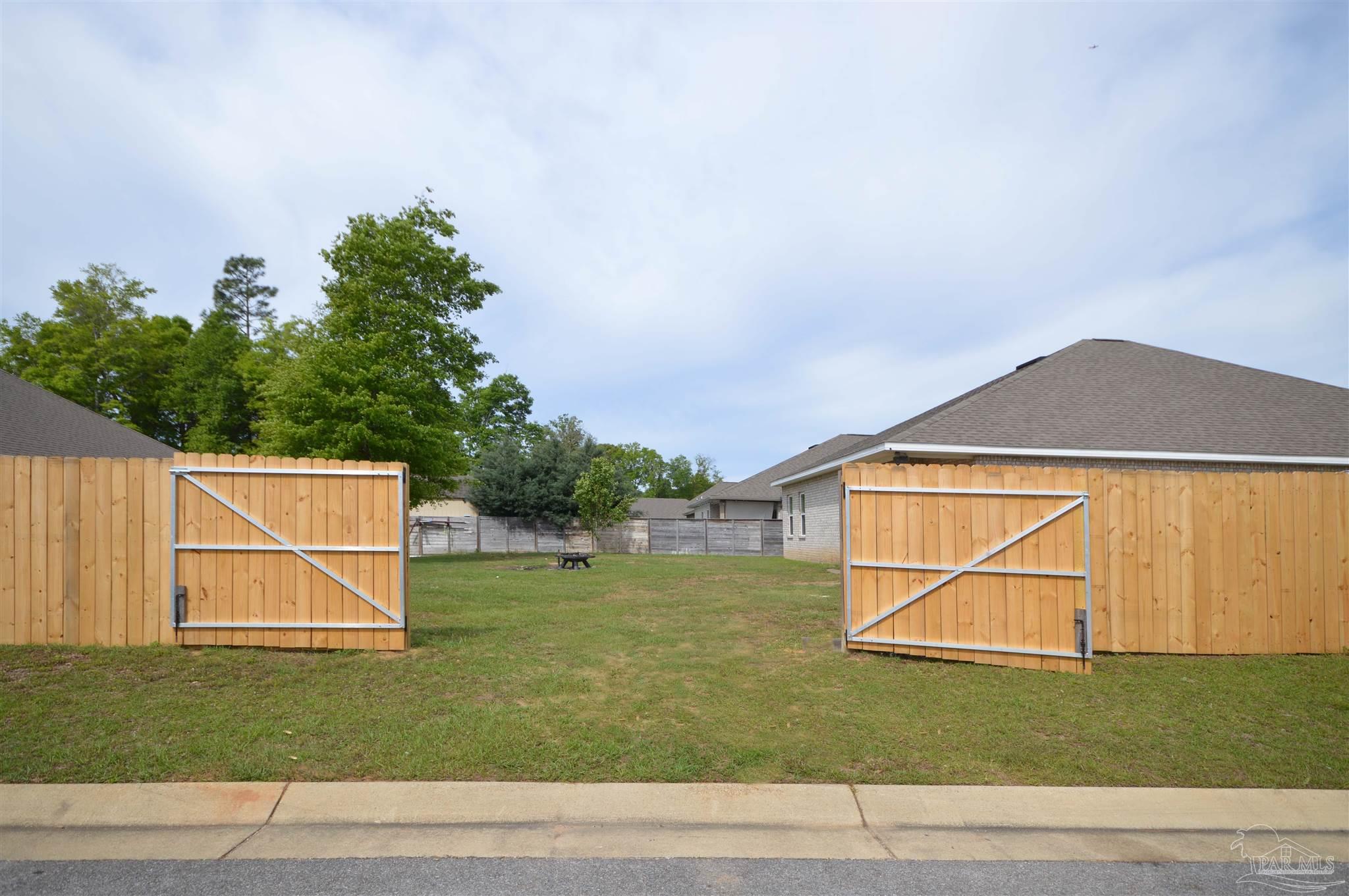 4453 Jude Way Pace, FL 32571 - Photo 41 of 41 a backyard of a house with lots of green space
