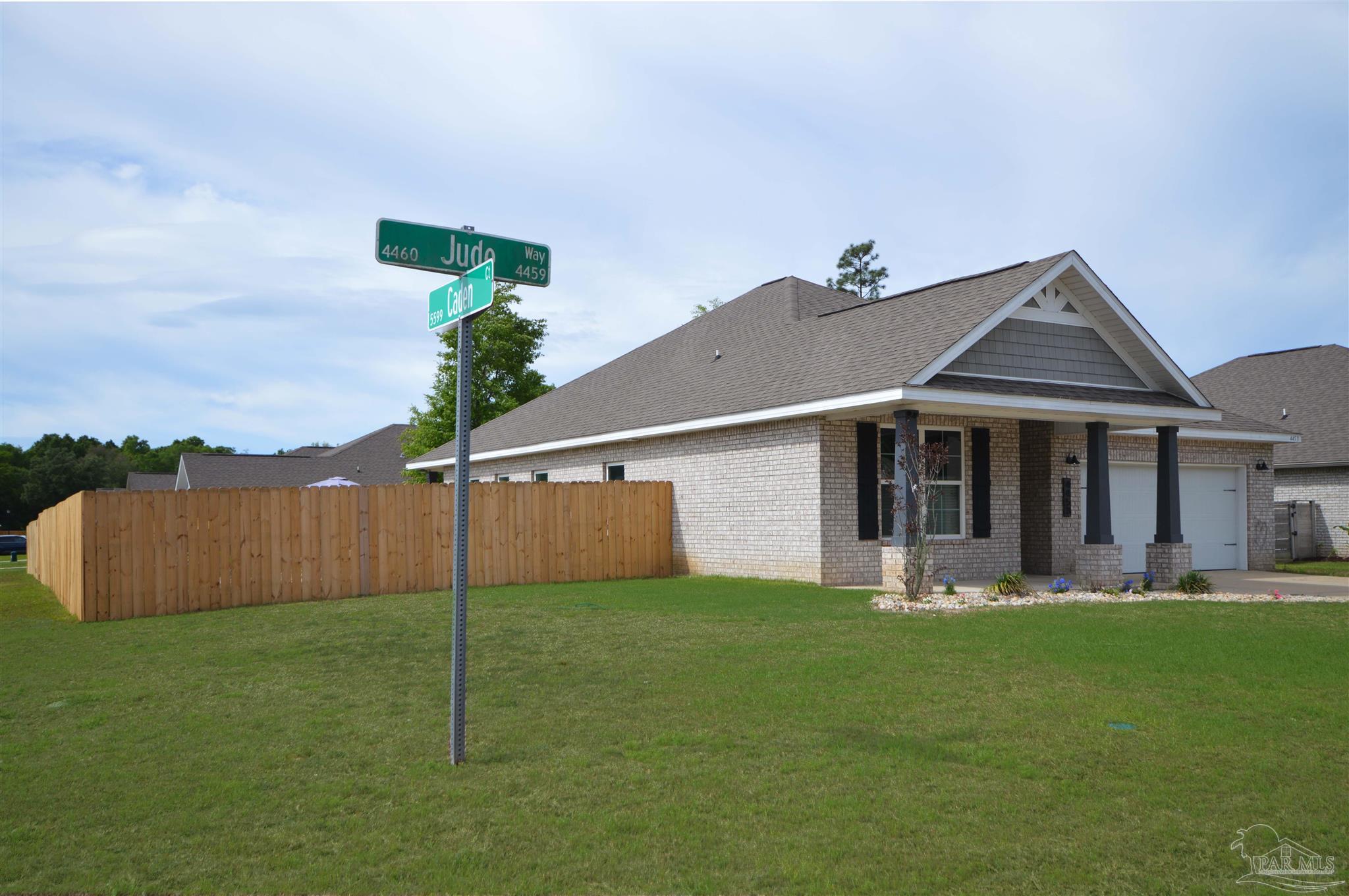4453 Jude Way Pace, FL 32571 - Photo 5 of 41 a front view of a house with a yard and trees