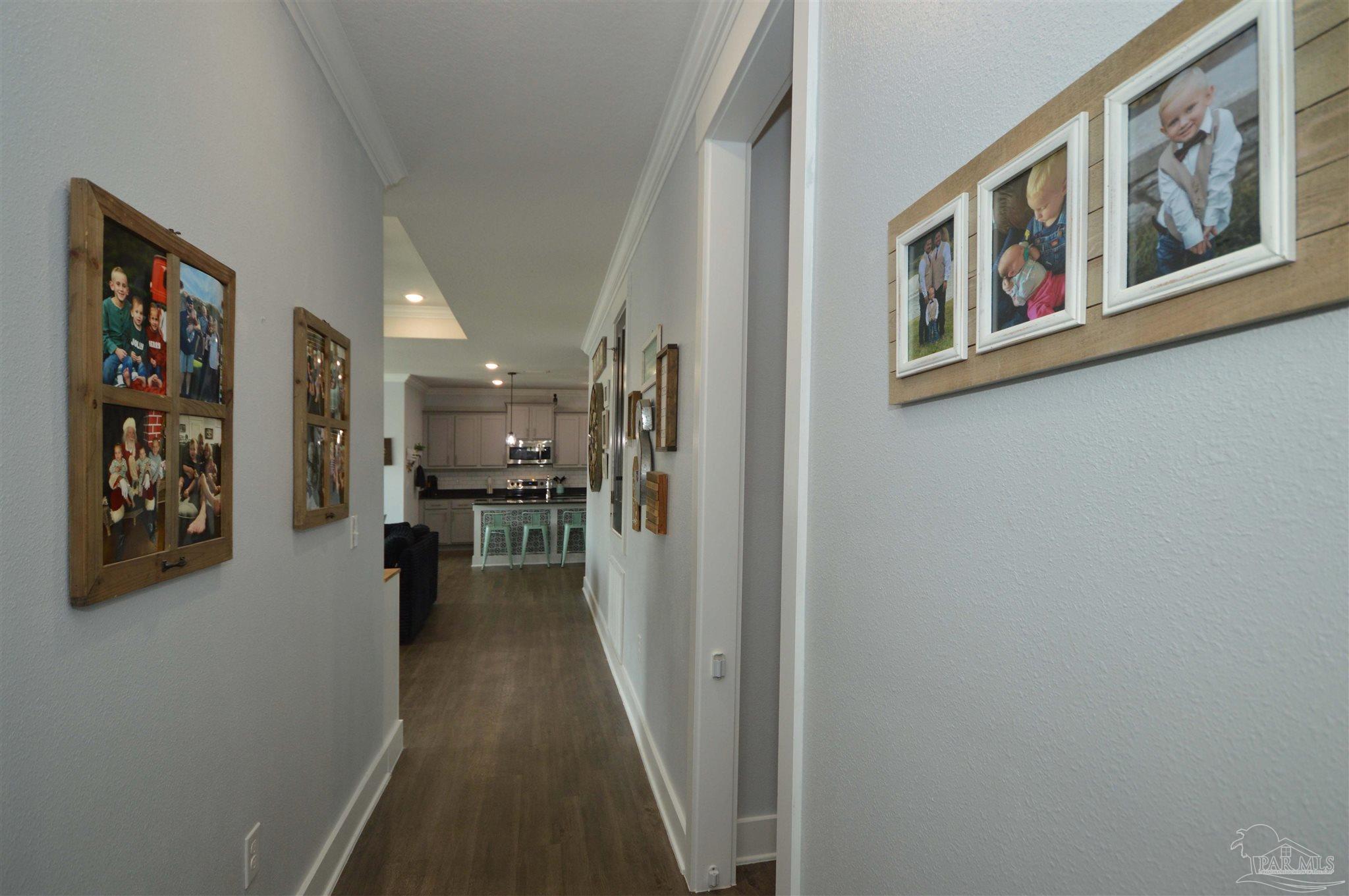 4453 Jude Way Pace, FL 32571 - Photo 7 of 41 a view of a hallway with wooden floor and living space