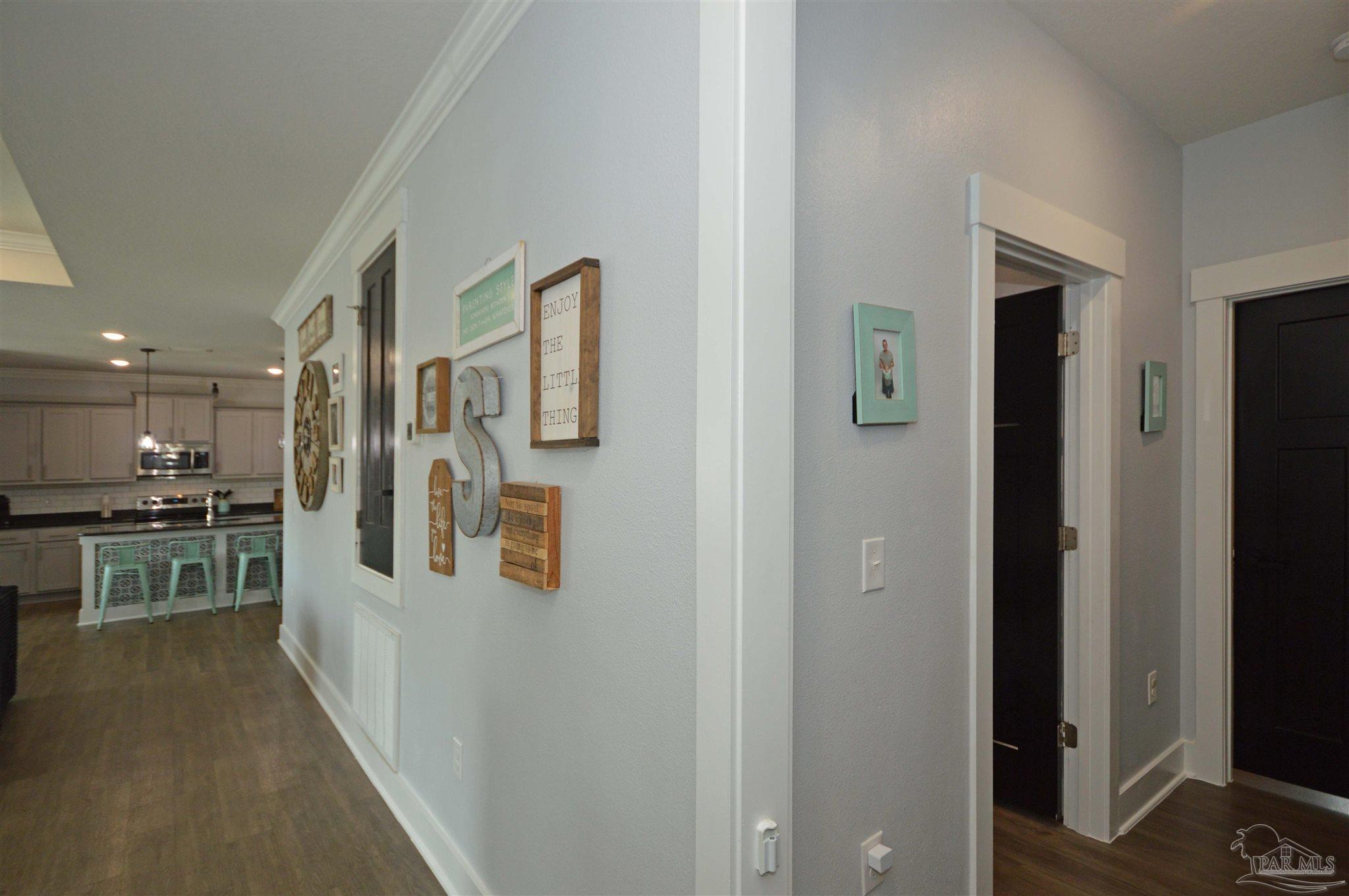 4453 Jude Way Pace, FL 32571 - Photo 8 of 41 a large white kitchen with stainless steel appliances