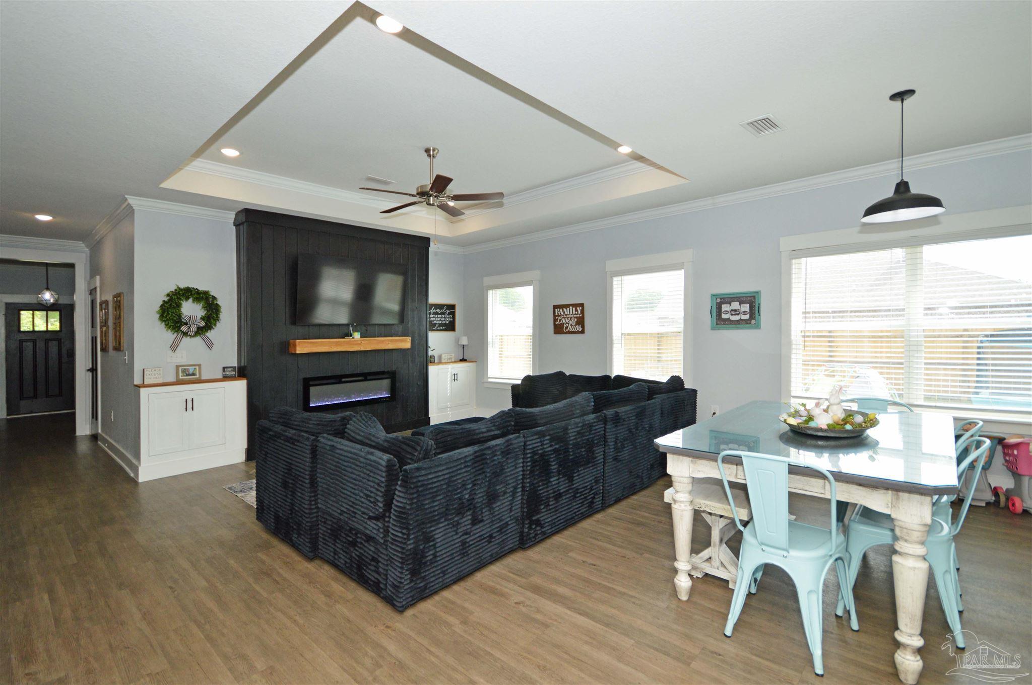 4453 Jude Way Pace, FL 32571 - Photo 9 of 41 a living room with furniture and a flat screen tv