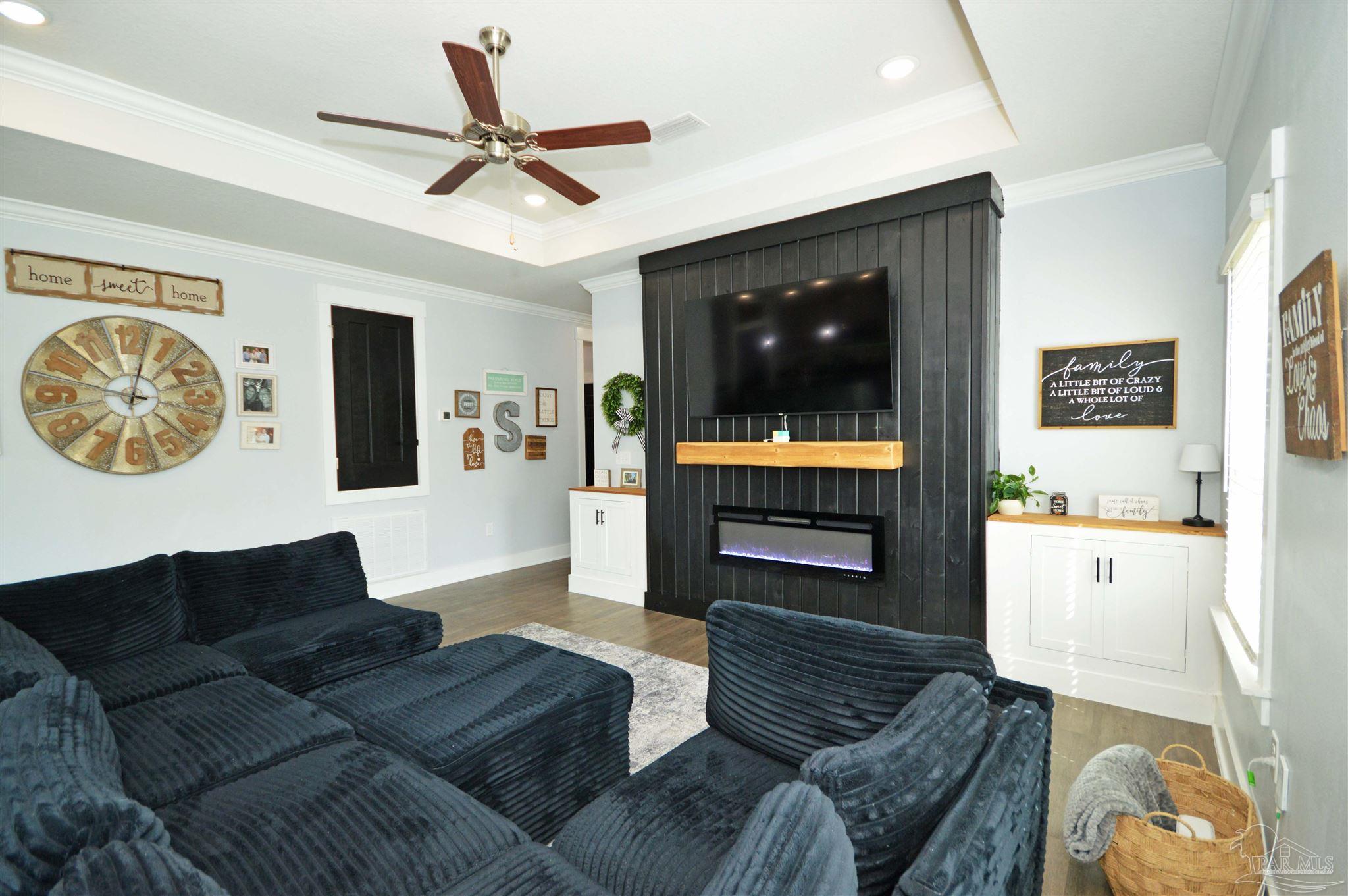 4453 Jude Way Pace, FL 32571 - Photo 10 of 41 a living room with furniture and a flat screen tv