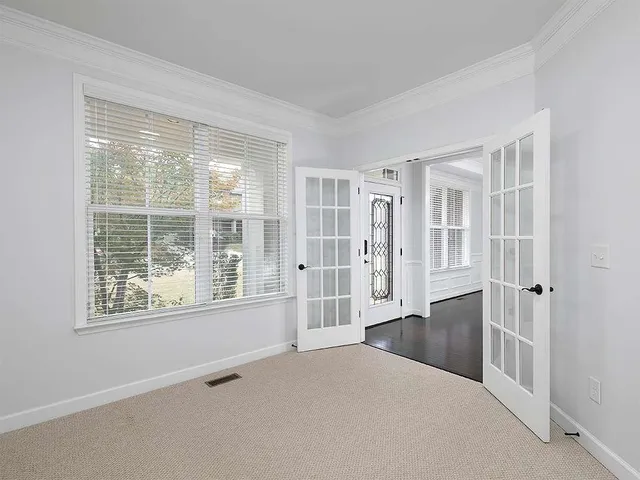 a view of an empty room with wooden floor