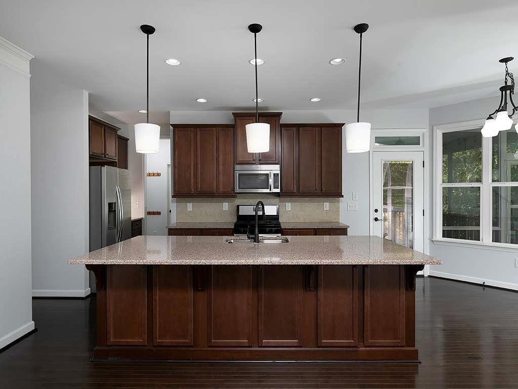 821 Tramore Road Acworth, GA 30102 - Photo 7 of 36 a kitchen with kitchen island granite countertop a sink a center island stainless steel appliances and cabinets