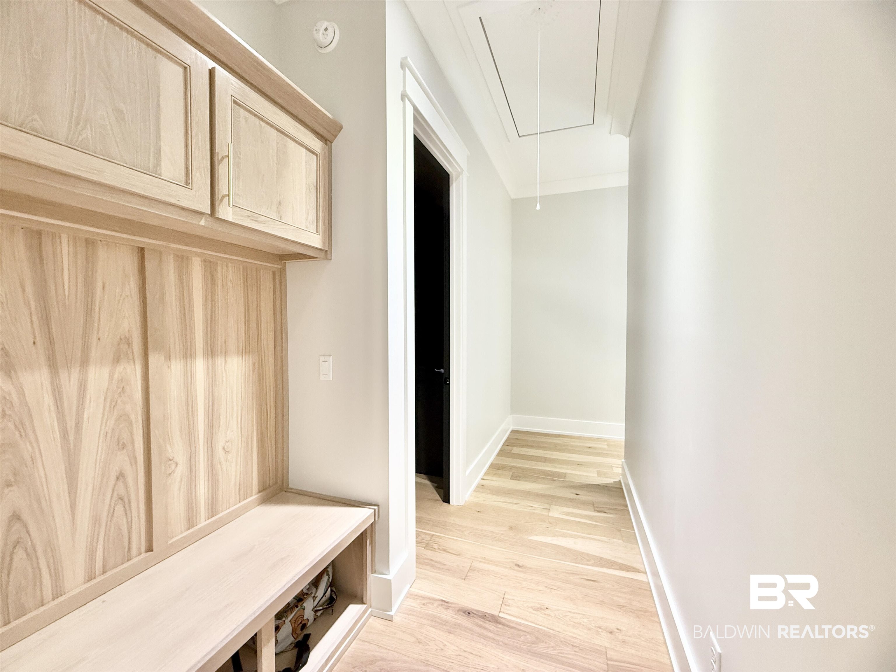 21767 Gallery Boulevard Fairhope, AL 36532 - Photo 53 of 74 Mudroom featuring attic access, light wood-style flooring, and ornamental molding