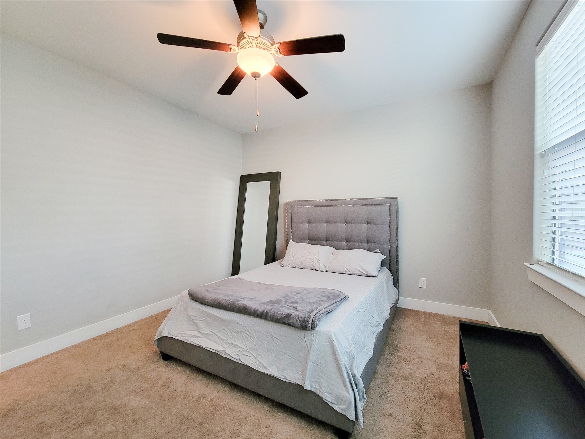 1424 Wilson Street Houston, TX 77019 - Photo 11 of 47 a bedroom with a bed ceiling fan and a window