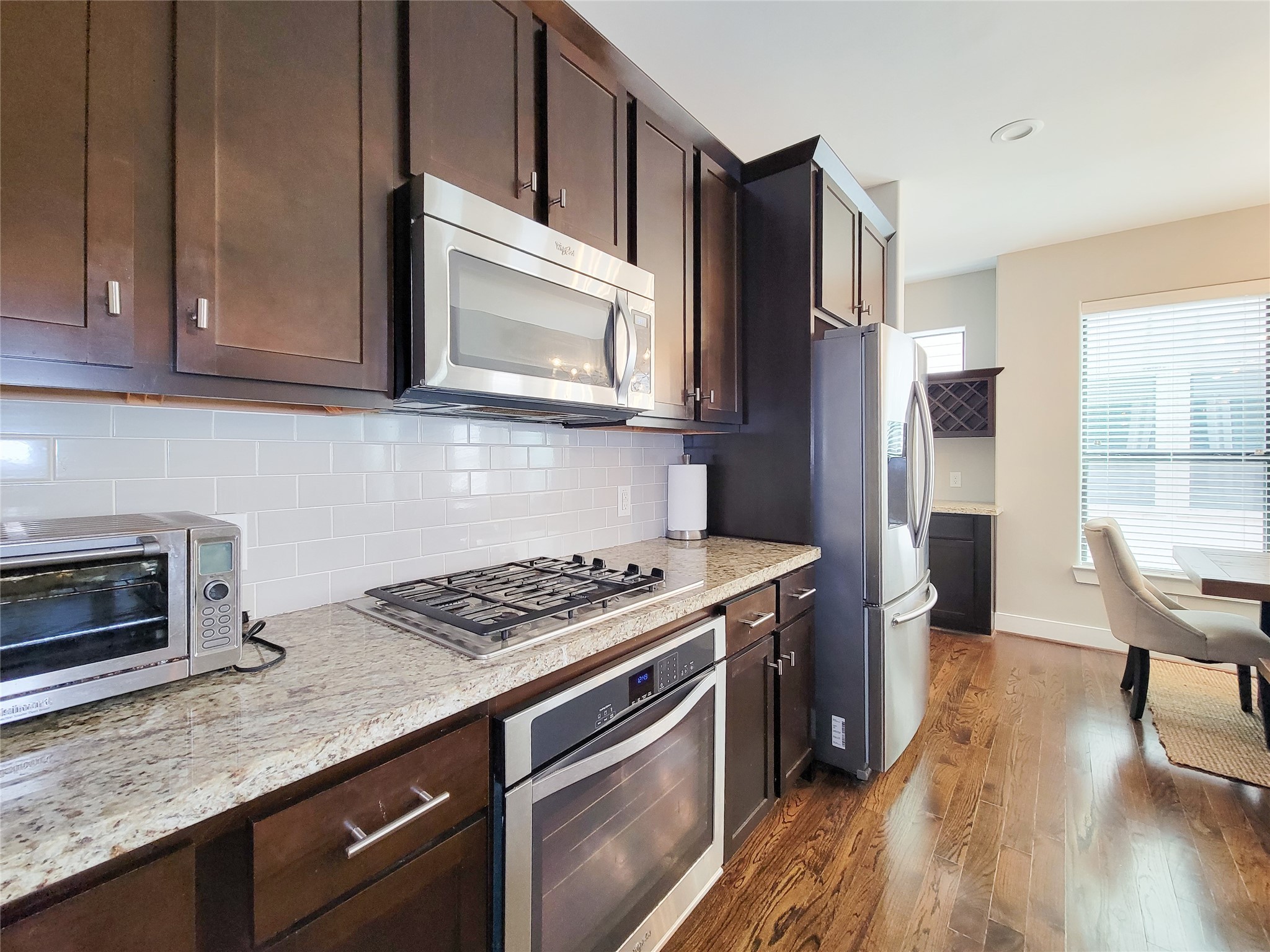 1424 Wilson Street Houston, TX 77019 - Photo 16 of 47 a kitchen with stainless steel appliances granite countertop a stove microwave and refrigerator