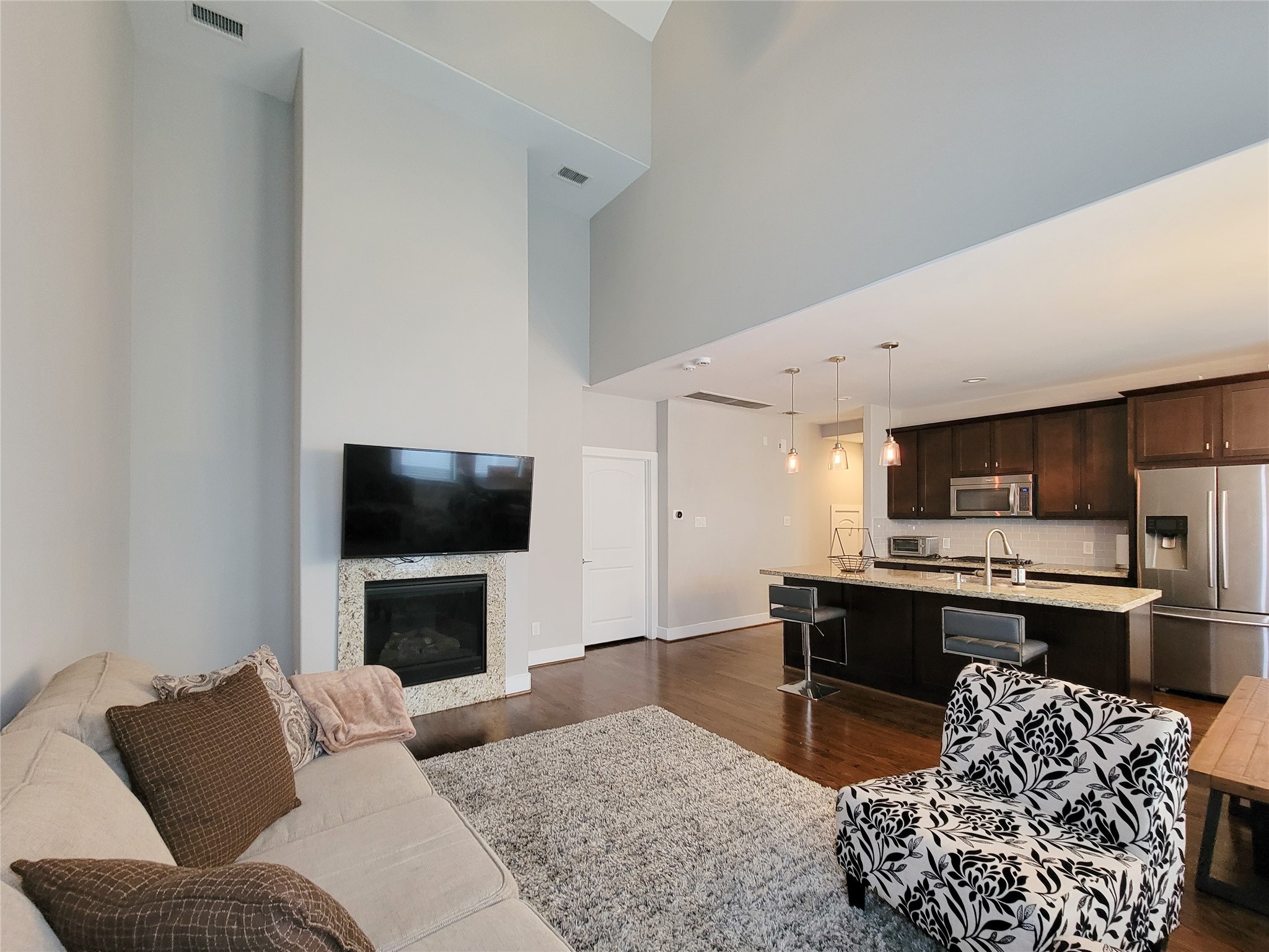 1424 Wilson Street Houston, TX 77019 - Photo 26 of 47 a living room with furniture a flat screen tv and a fireplace